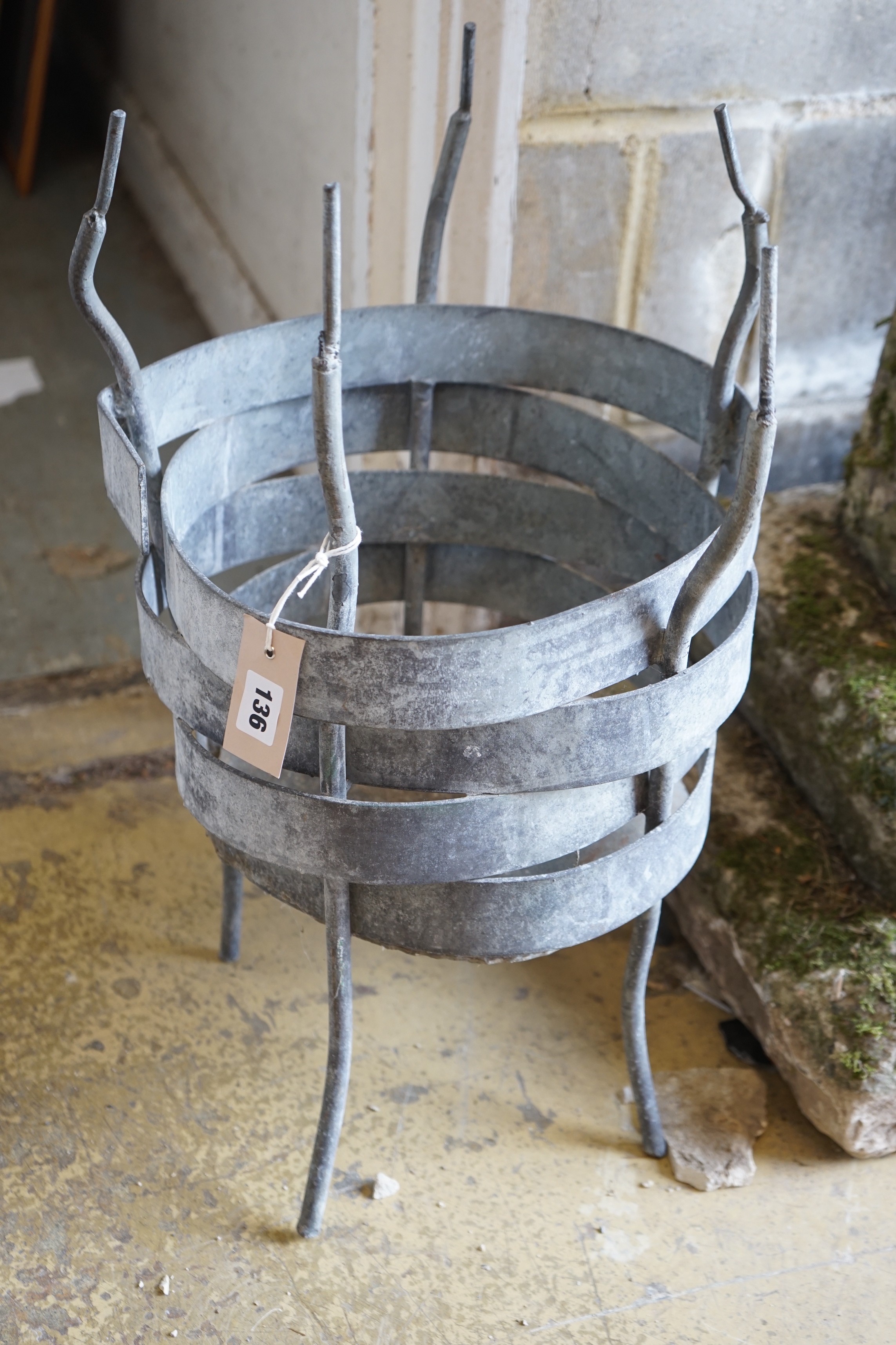 A circular wrought iron planter, height 58cm